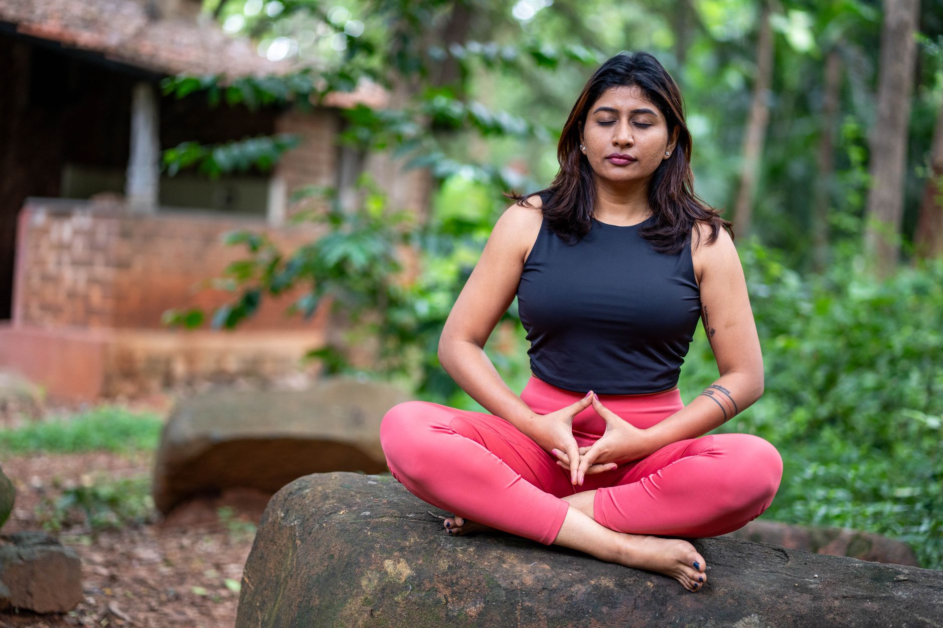 woman meditating outdoors in serene setting